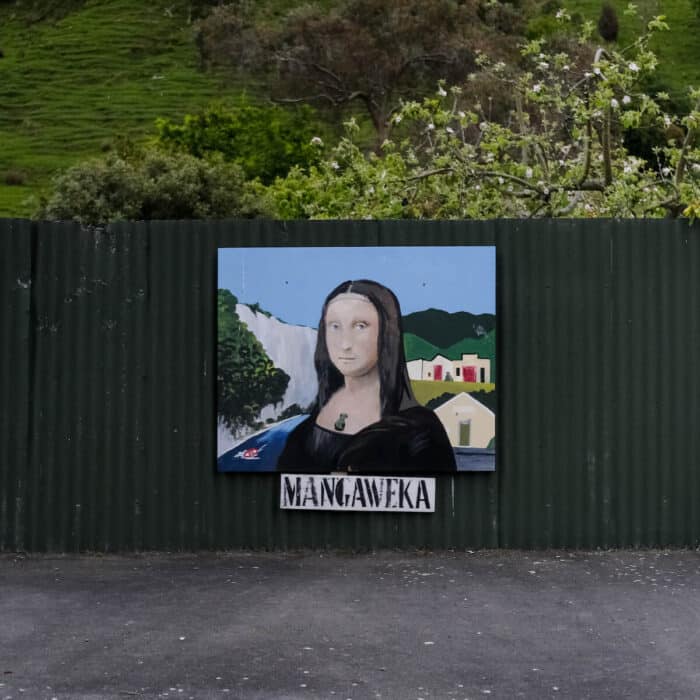 Mona Lisa with a Mangaweka backdrop, painted on a fence