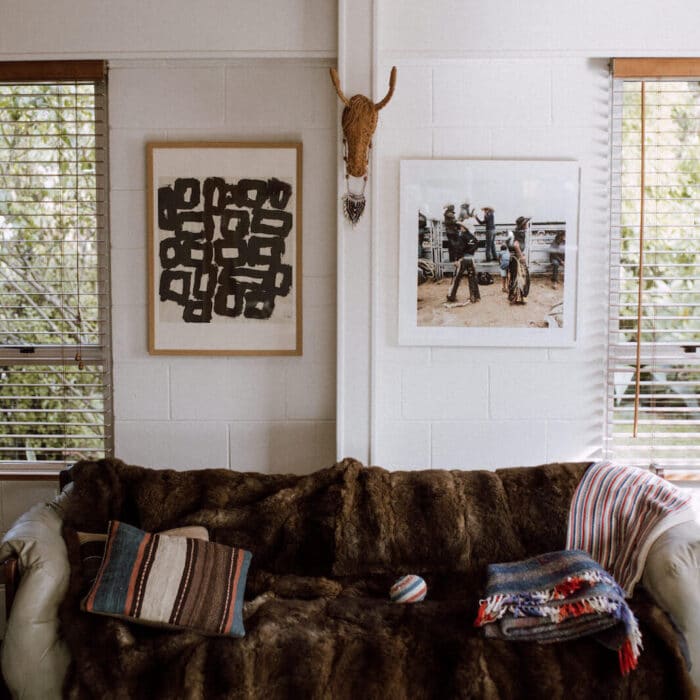 In Philippa's living room; framed print and photo on the wall, fur blanket on the couch